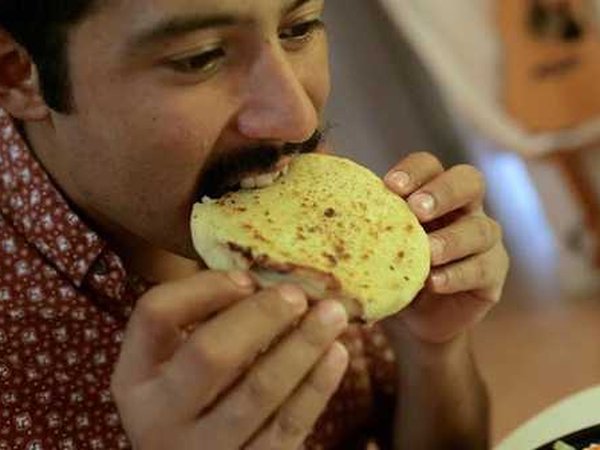 Rodriguez eating pupusas