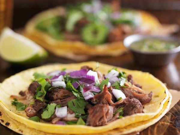 authentic mexican street tacos with barbacoa beef on yellow corn tortilla
