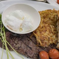 Close up shot of a plate of fried steak, poached eggs and hash brown, ate at Sedona, Arizona