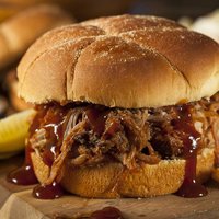 Barbeque Pulled Pork Sandwich with BBQ Sauce and Fries