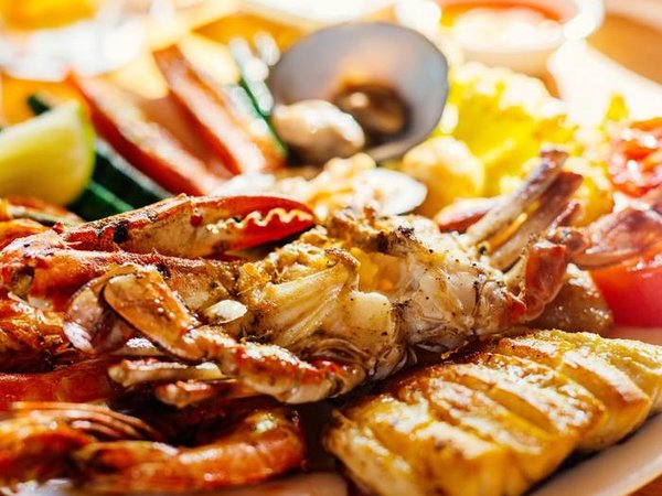 Close up of delicious grilled vegetables and seafood