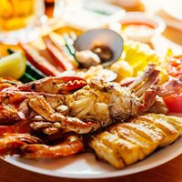 Close up of delicious grilled vegetables and seafood