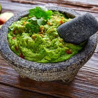 avocado Guacamole on molcajete real Mexican traditional procedure