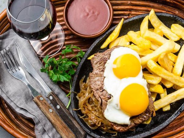 Peruvian Latin American food. Lomo a lo pobre. Beef tenderloin whit fried potatoes french fries and eggs