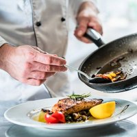 Chef finishing food in his restaurant kitchen