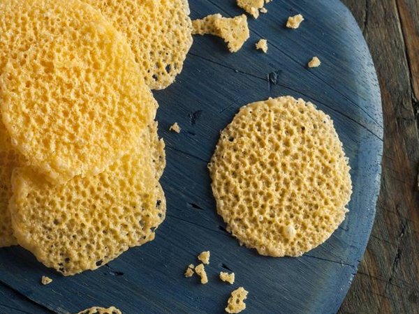 Homemade Parmesan Cheese Crisps on a Cutting Board