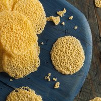 Homemade Parmesan Cheese Crisps on a Cutting Board