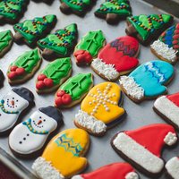 A variety of beautifully decorated Christmas sugar and gingerbread cookies on a baking sheet