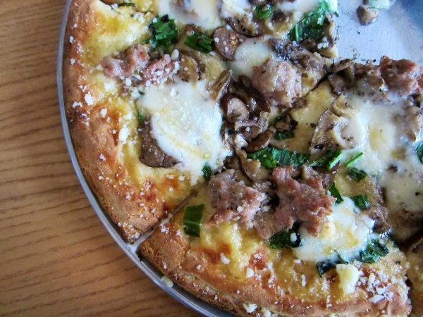 Harvest Pizza with ramps! Delicious! The special featured wild ramps from Ohio and West Virginia, truffled mushrooms from Athens County, fennel sausage, Taleggio cheese and local honey.