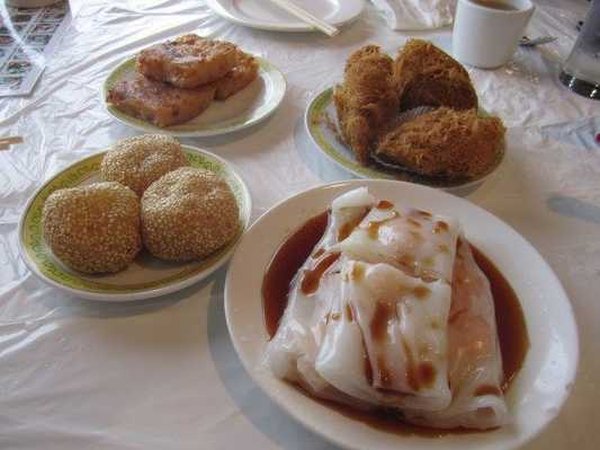 (Upper left and moving clockwise) Turnip cakes, taro puffs, shrimp wraps, and sesame balls