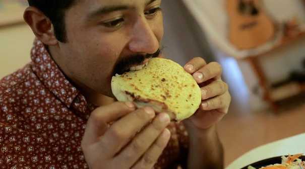 Rodriguez eating pupusas