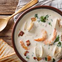 American food: New England clam chowder soup close-up on a in a bowl on the table. horizontal view from above